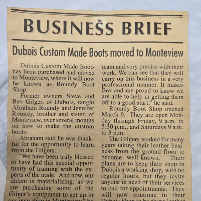 A newspaper clipping headed Business Brief, 'Dubois Custom Made Boots moved to Monteview', reporting that Steve and Bev Gilger of Dubois taught Abraham and Jennifer Roundy of Monteview to make the custom boots and that the shop would be known as Roundy Boot Shop.