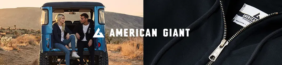 Two people in dark hoodies sit in the back of a blue vehicle in a desert landscape, beside a close-up of a black zip hoodie with an American Giant label and white brand lettering.