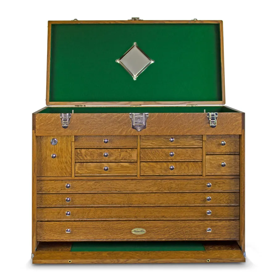An open golden-oak tool chest with a bank of small drawers, a green felt-lined lid with a mirror, and a brass nameplate, shown front-on against a white background.