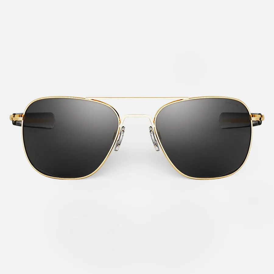 A pair of gold-framed aviator sunglasses with dark gray lenses, shown front-on against a plain white studio background.