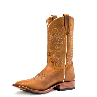 A single tan-brown square-toed cowboy boot with an 11-inch shaft, pale scrolled stitching on the shaft, a stacked leather heel and a natural welt, shot at an angle on a white background.