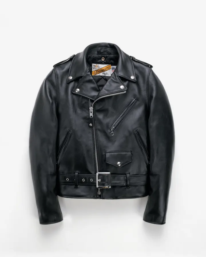 A black steerhide leather motorcycle jacket with an asymmetric zip front, belt, and orange 'Perfecto' label at the collar, laid flat against a white background.
