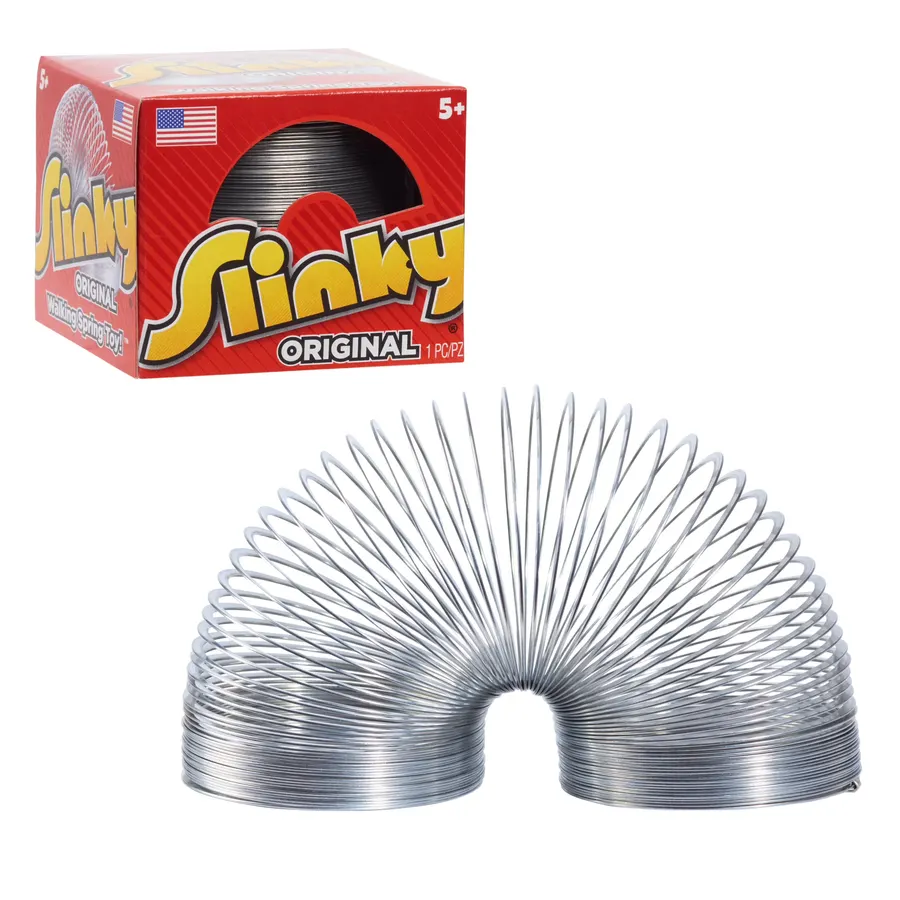 A silver metal coil spring toy arched into a loop, standing in front of its red and yellow 'Slinky Original' retail box.